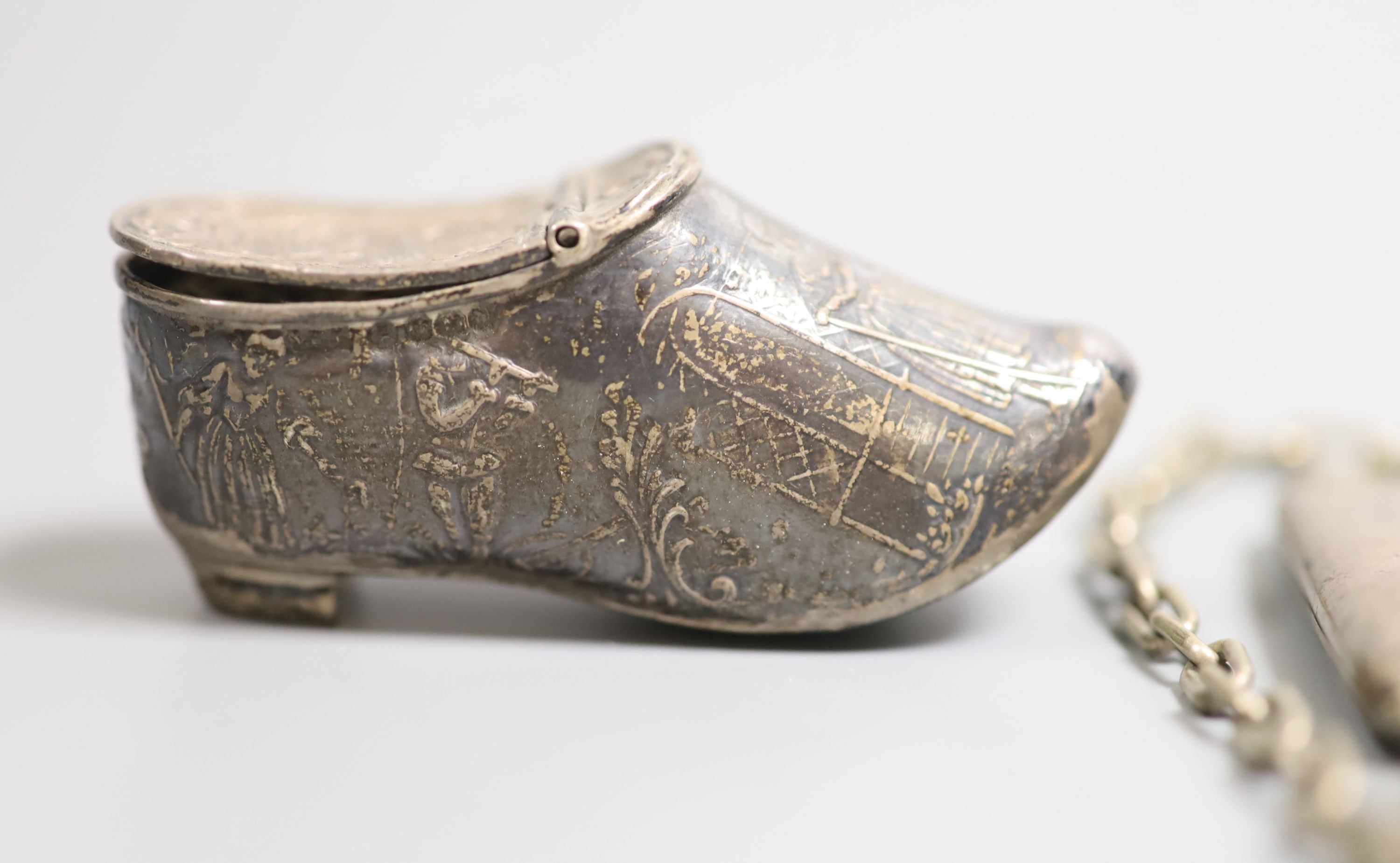 A late Victorian silver shoe vinaigrette, import marks for Sheffield, 1896, 7cm, one other continental white meta box, a silver cigarette case and a mesh evening bag.